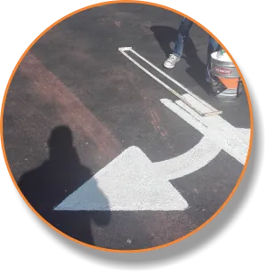 White arrow road marking painted on dark tarmac